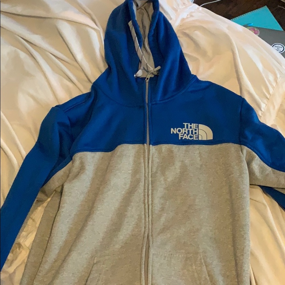 zip up blue and grey north face sweatshirt